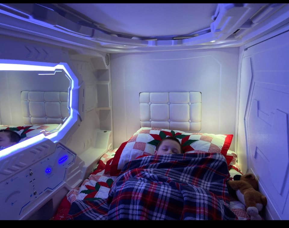 kid sleeping in zpods bed with blue lighting